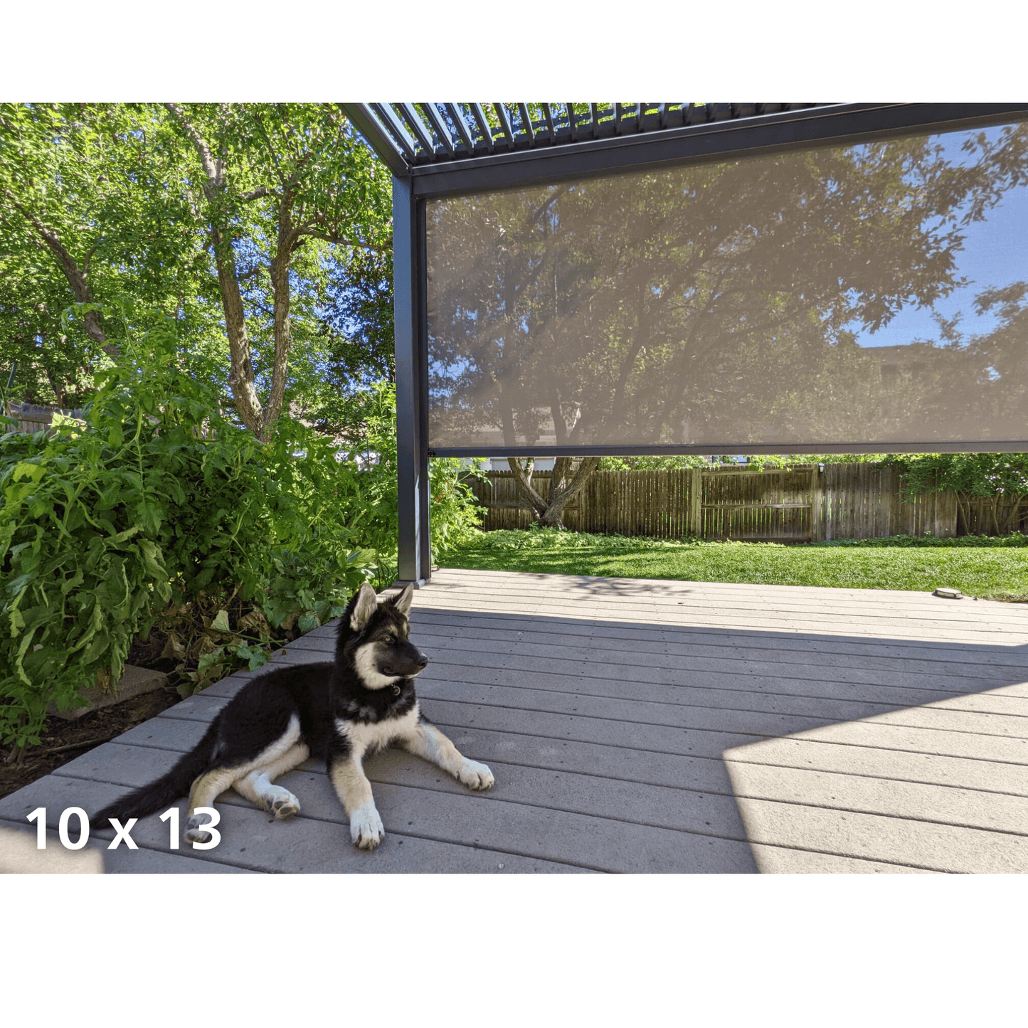 The gray Bon Pergola 10x13 features motorized louvers partially open, casting sleek, linear shadows below. Its structure is built with dark gray posts and beams, offering a clean, modern look. One side of the pergola is fitted with a light-colored shade screen for added sun protection and privacy.