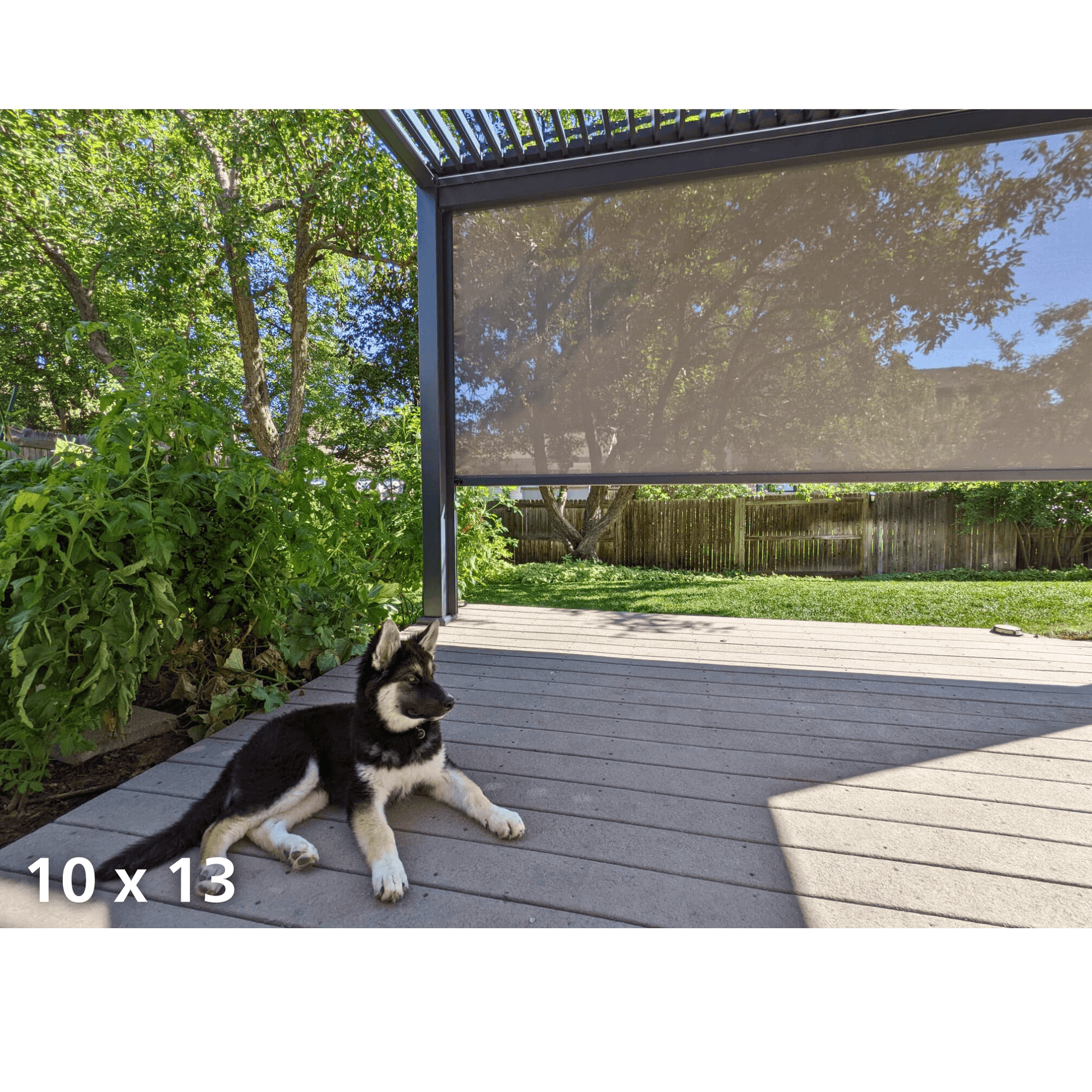 The gray Bon Pergola 10x13 features motorized louvers partially open, casting sleek, linear shadows below. Its structure is built with dark gray posts and beams, offering a clean, modern look. One side of the pergola is fitted with a light-colored shade screen for added sun protection and privacy.