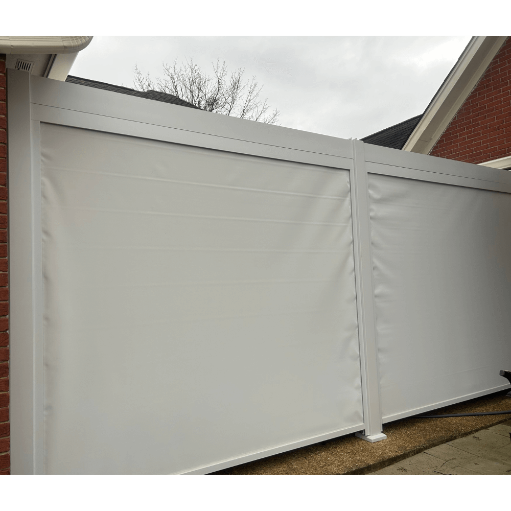 A white Bon Pergola with side-mounted windproof sunshade screens. The pergola is fitted with heavy-duty white roller shades that are nearly fully lowered. The posts and beams frame two large white screens that almost completely enclose the sides, leaving only a small gap at the bottom. The material looks thick and durable, designed to effectively block wind and sunlight, while also offering some level of water resistance—perfect for added protection and comfort.