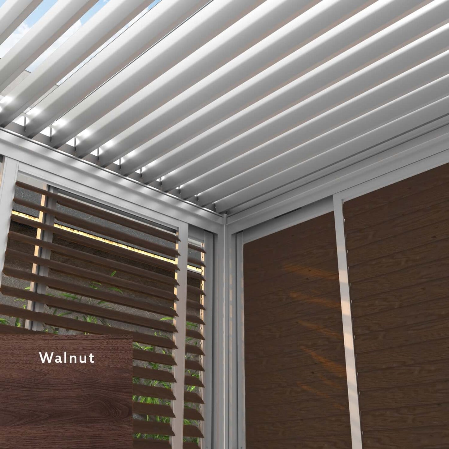 The white Bon Pergola features a louvered roof, with its sides framed in white. Some sections are fitted with walnut-colored horizontal louvers and matching wood-look panels. This image highlights the refined contrast between the pergola’s clean white structure and the rich walnut tones of the sliding shutters and decorative cladding, showcasing a sophisticated blend of modern and natural aesthetics.