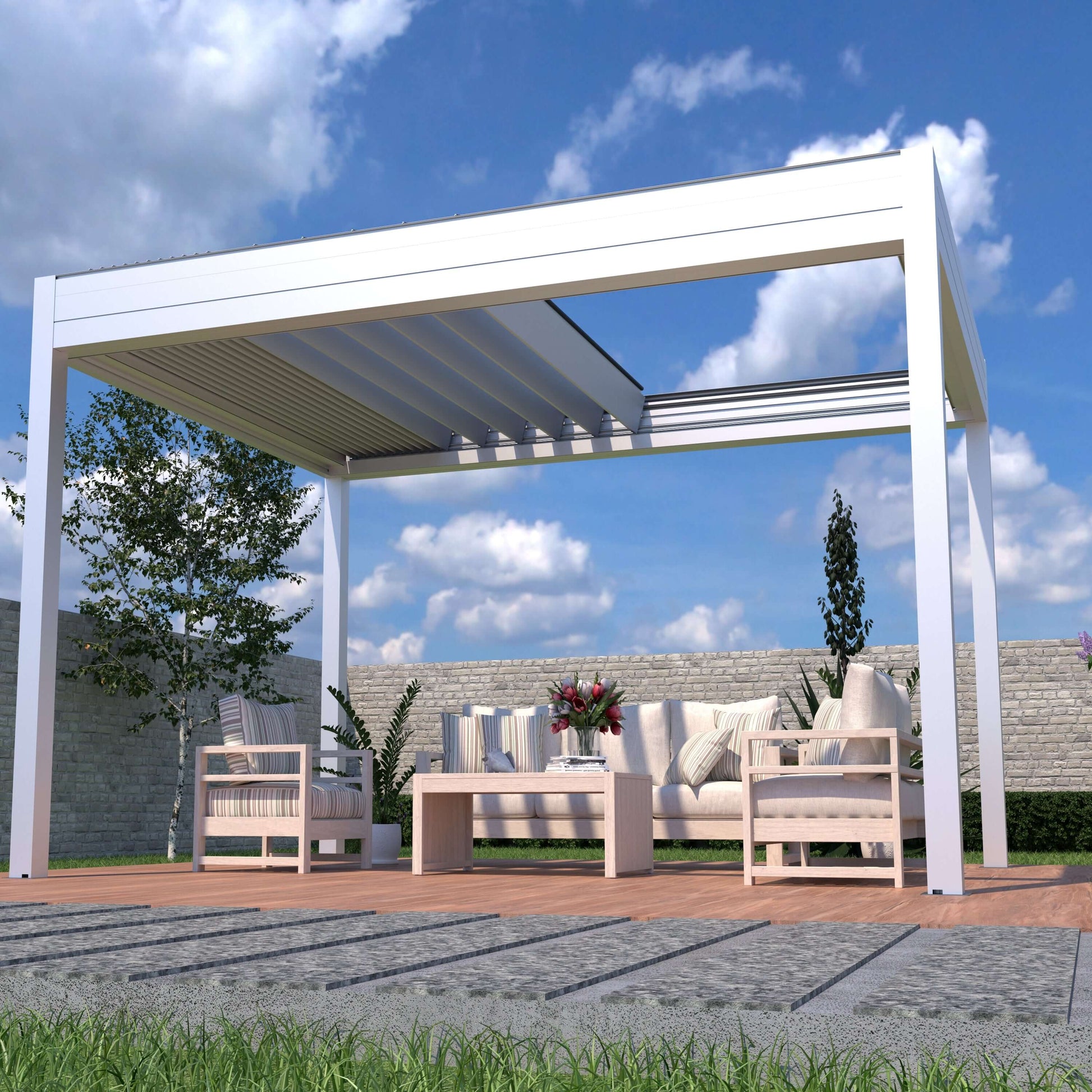 The white pergola The white pergola has its shade partially retracted, showing white beams and light gray louvers. It features sturdy white posts and beams with a modern design. Below, a set of beige outdoor furniture includes a long sofa, two armchairs, and a rectangular coffee table with flowers, books, and decor. The sofa and chairs have striped and solid cushions. The pergola is surrounded by green plants and trees, with a light-colored fence in the background.
