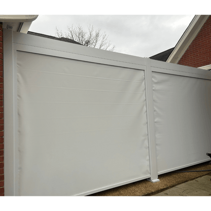 A white Bon Pergola with side-mounted windproof sunshade screens. The pergola is fitted with heavy-duty white roller shades that are nearly fully lowered. The posts and beams frame two large white screens that almost completely enclose the sides, leaving only a small gap at the bottom. The material looks thick and durable, designed to effectively block wind and sunlight, while also offering some level of water resistance—perfect for added protection and comfort.