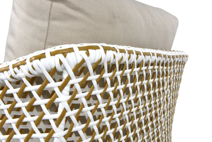 The thick seat and back cushions are upholstered in light beige, linen-textured fabric. The white and brown woven strips are intricately interlaced, creating a bamboo-like pattern that weaves both above and below each other, forming a layered, mesh-like structure.