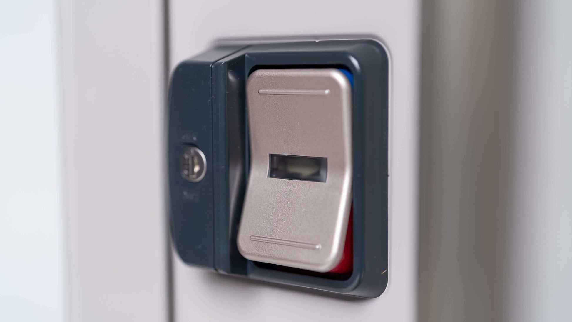Close-up of a fingerprint scanner on the YODOKO Premium Outdoor Large Shed LMDS by BON PERGOLA, showcasing Japanese craftsmanship with a metallic sensor plate and small square screen for biometric access. The design echoes precision and elegance.