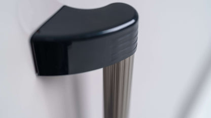 Close-up of YODOKO Premium Outdoor Large Shed LMDS from BON PERGOLA, featuring a metallic handle with a black curved plastic grip, highlighting Japanese craftsmanship. The shiny pole and durable coating enhance resilience, while the out-of-focus background complements its sleek design.