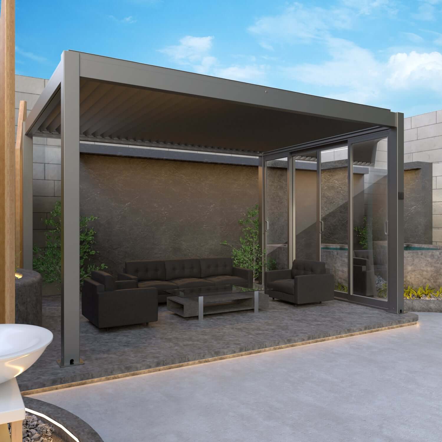 The dark gray Bon Pergola features fully closed louvers, creating a solid roof for complete shade. Its structure is built with thick dark gray beams and posts, forming a semi-enclosed outdoor space. One side is fitted with Bon Pergola Premium Sliding Glass—multi-panel glass sliding doors with dark gray frames. The doors are partially open, blending indoor comfort with outdoor living.