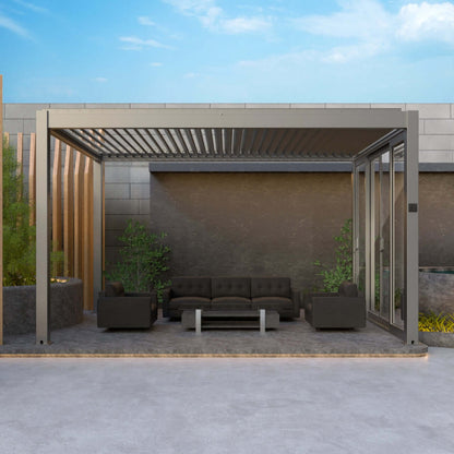 Under the dark gray Bon Pergola sits a platform with matching dark gray flooring, furnished with a sleek outdoor set that includes a deep gray sofa, two armchairs, and a light gray coffee table. Hidden LED floor lights along the platform’s edge likely add a soft, ambient glow. The all-dark gray setup creates a modern, sophisticated vibe perfect for relaxing outdoors.