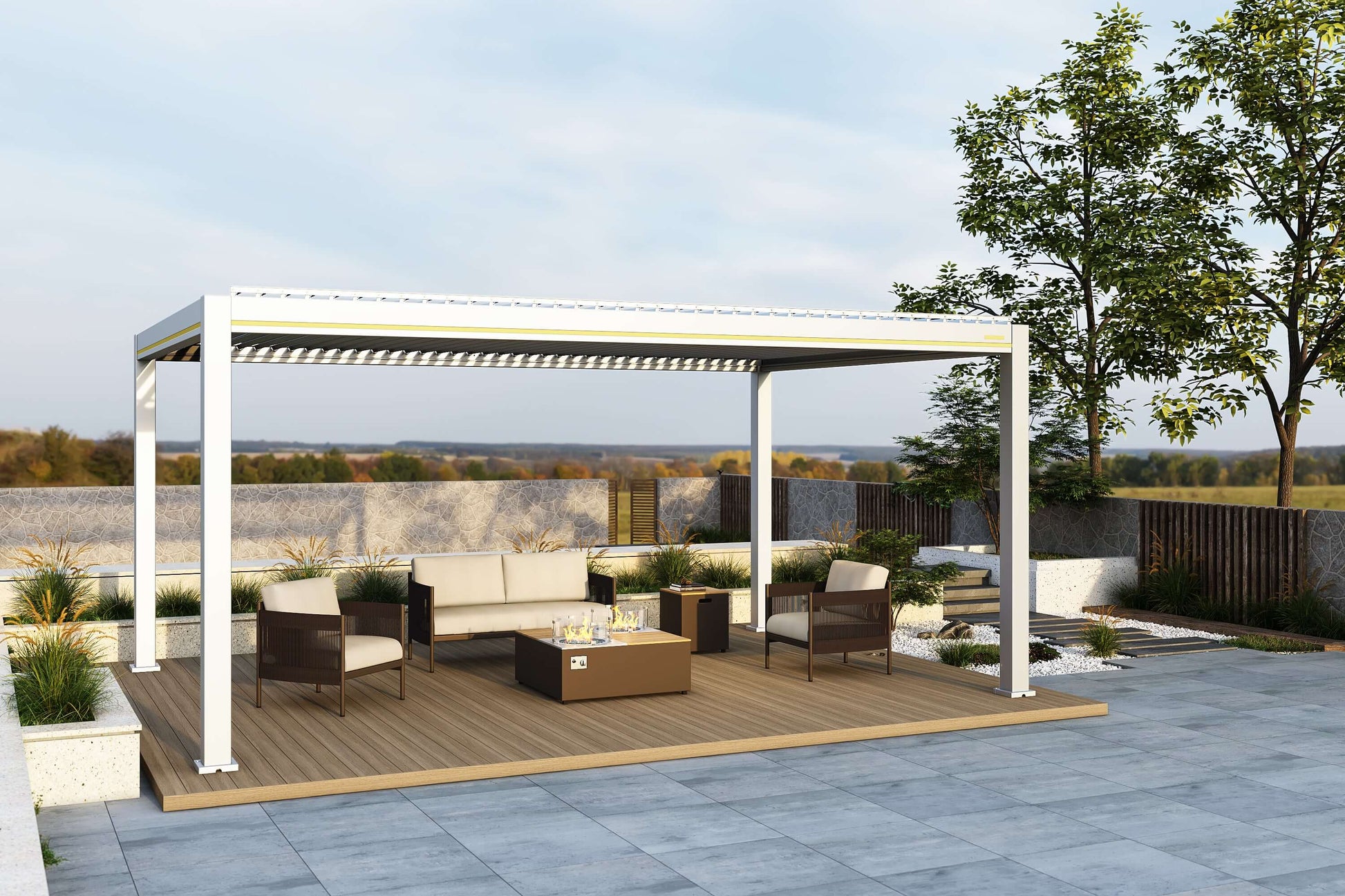 A white Villa Pergola with the louvers partially open, featuring a yellow decorative trim along the top. Beneath the pergola is a beige sofa with a dark frame, two deep brown woven armchairs with light-colored cushions, and a wooden fire pit table. The table has a gas fire pit in the center, surrounded by a transparent glass wind guard.