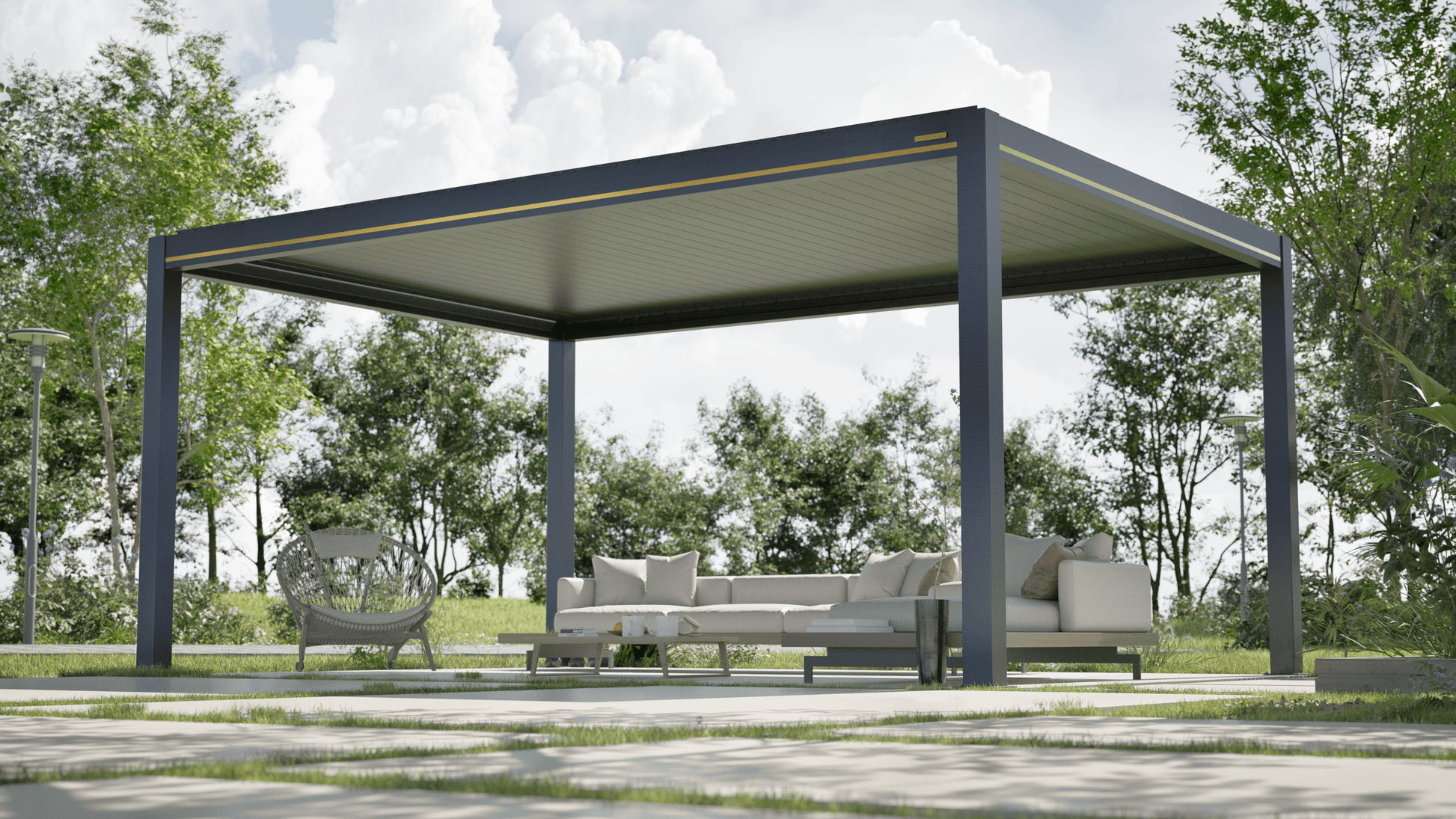 The black pergola features a closed louvered roof, creating a smooth gray canopy. Its structure is made of sturdy gray posts and beams, with slim gold accents along the top and bottom of the beams. The floor is light gray, and the space is furnished with beige outdoor lounge furniture, including an L-shaped sofa, a single armchair, and a small side table. The sofa is adorned with light-colored cushions for added comfort.