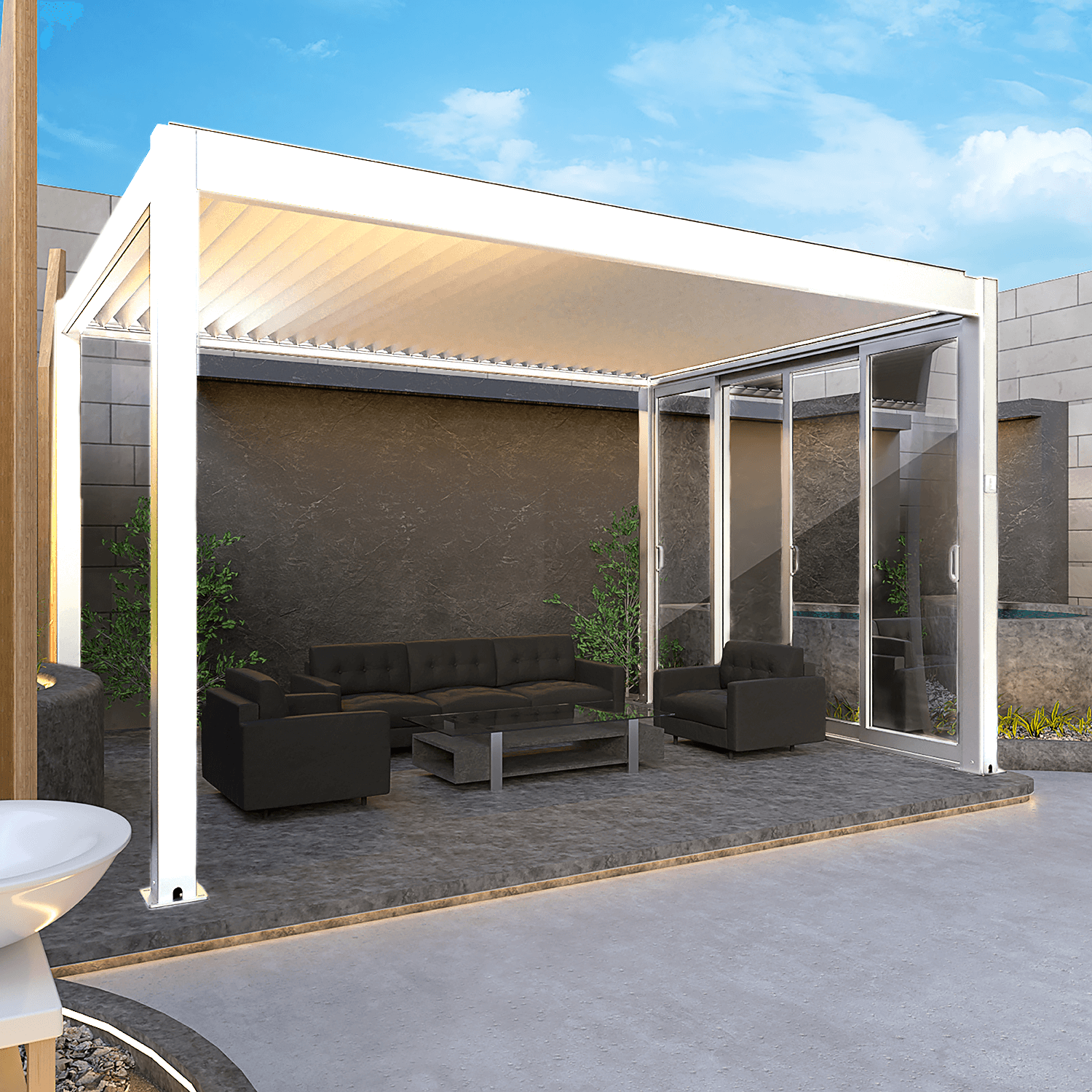 The white pergola features a partially extended shade canopy, revealing white beams and some of the white louvers. Its structure is supported by sturdy white posts and beams in a sleek, modern design. One side includes white-framed sliding glass doors, partially open to connect the space with the surrounding outdoor environment.