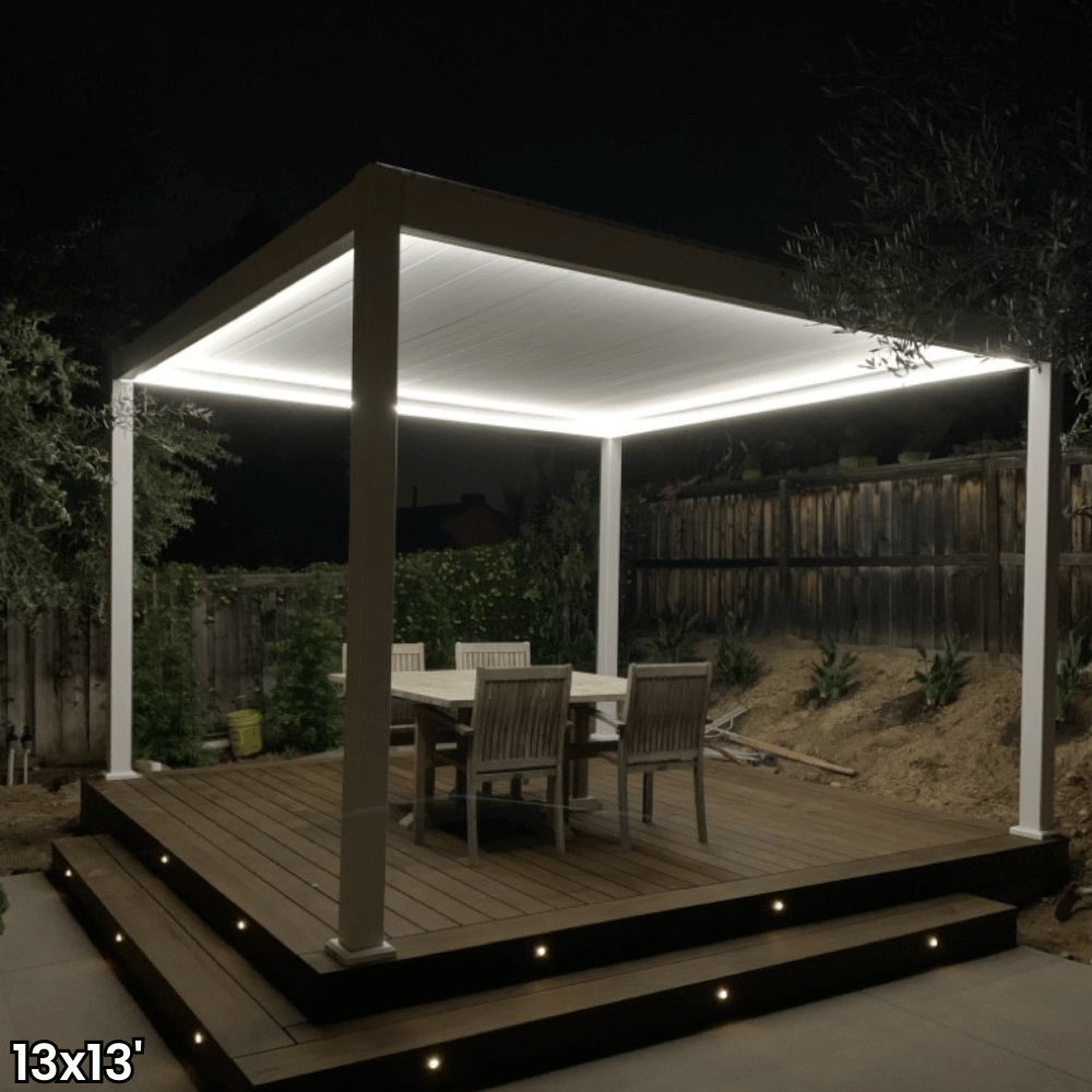 A white aluminum pergola with a motorized louvered roof and LED lighting. Perfect for shade, sun protection, and outdoor gatherings.