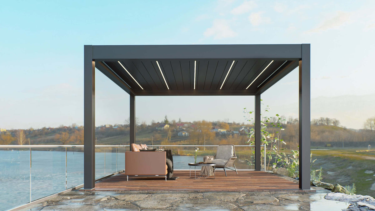 The deep gray Pergola features a partially opened louvered roof, showcasing the dark gray louvers with a white LED lighting strip embedded between them, visible even during the day. The structure is made of sturdy deep gray columns and beams, creating a modern and minimalist design.